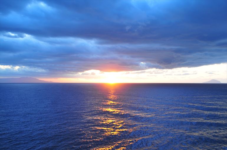 美しい光が海を走る日の出の眺望